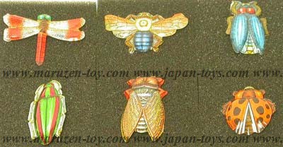 Tin toy insect badge in a plastic case 
